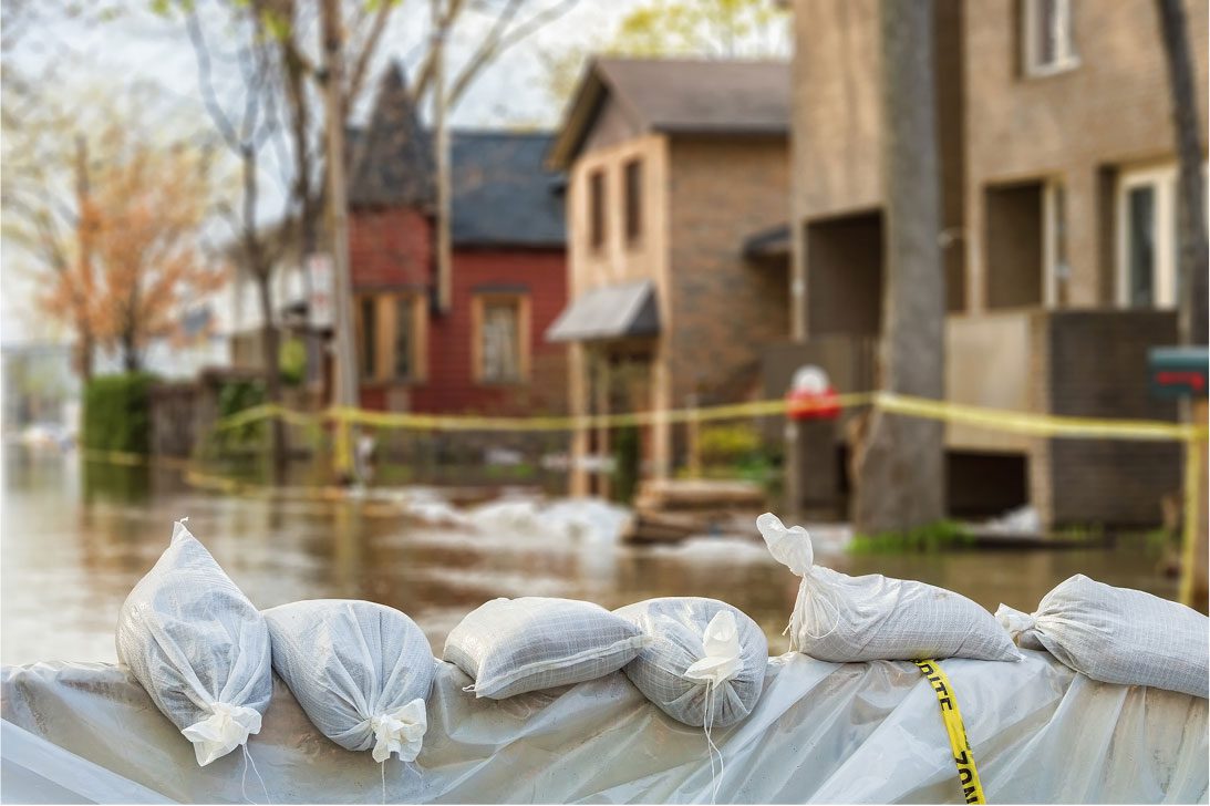 Piles of sandbags stacked on a street for flooded street, used for emergency management and disaster response efforts.